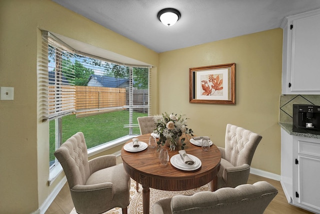 7015 Grackle Dr, Cypress, TX 77433 - dining area featuring plenty of natural light, light wood finished floors, and baseboards