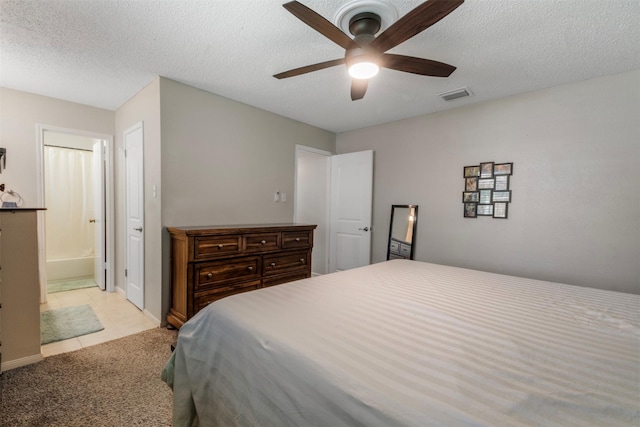 19414 Gooselake Ln, Houston, TX 77084 - bedroom featuring light carpet, a textured ceiling, a ceiling fan, and ensuite bathroom