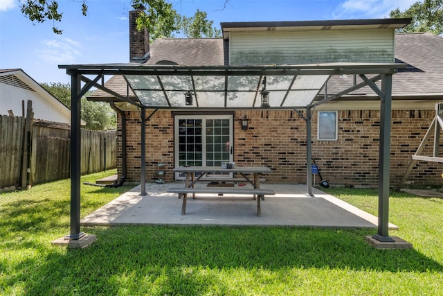 19414 Gooselake Ln, Houston, TX 77084 - back of house featuring a chimney, brick siding, a shingled roof, and a patio area