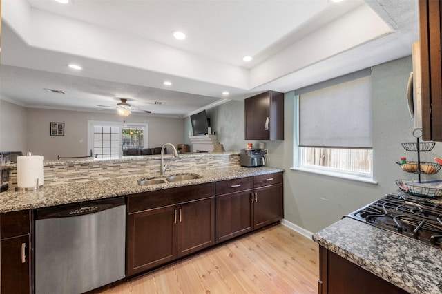 19414 Gooselake Ln, Houston, TX 77084 - kitchen featuring dishwasher, a sink, light wood-style floors, dark brown cabinetry, and light stone countertops