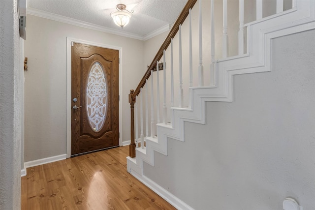 19414 Gooselake Ln, Houston, TX 77084 - entrance foyer with stairway, light wood-style flooring, baseboards, crown molding, and a textured ceiling