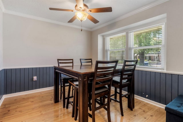 19414 Gooselake Ln, Houston, TX 77084 - dining area with light wood-type flooring, wainscoting, a ceiling fan, and ornamental molding