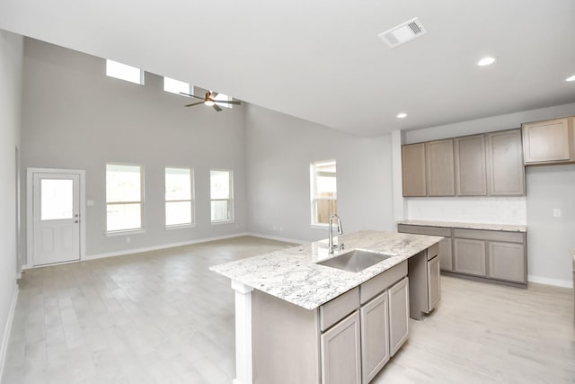 12027 Maple Oak Dr, Houston, TX 77066 - kitchen with a sink, ceiling fan, an island with sink, recessed lighting, and light wood-style flooring