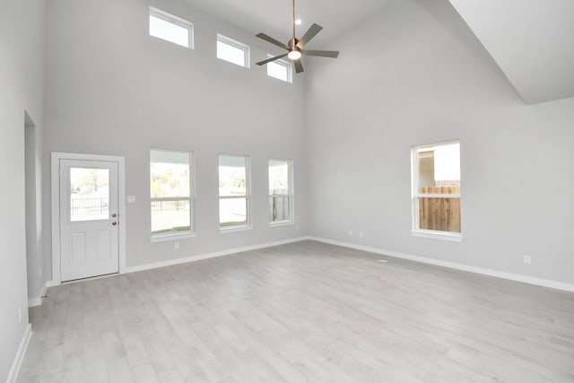 12027 Maple Oak Dr, Houston, TX 77066 - unfurnished living room featuring high vaulted ceiling, a ceiling fan, wood finished floors, and baseboards