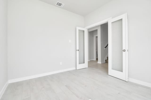 12027 Maple Oak Dr, Houston, TX 77066 - empty room featuring light wood-style flooring, baseboards, and stairs