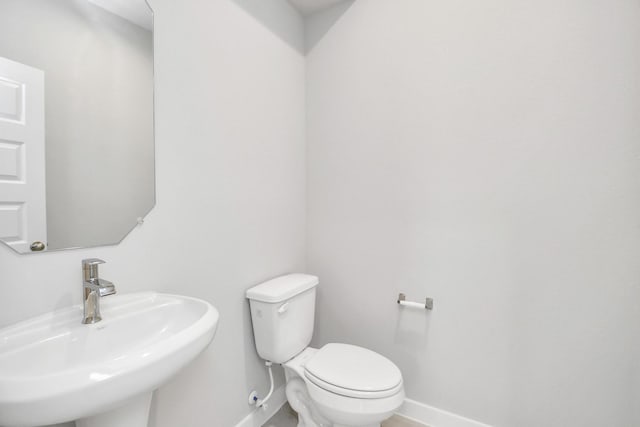 12027 Maple Oak Dr, Houston, TX 77066 - bathroom featuring a sink, baseboards, and toilet