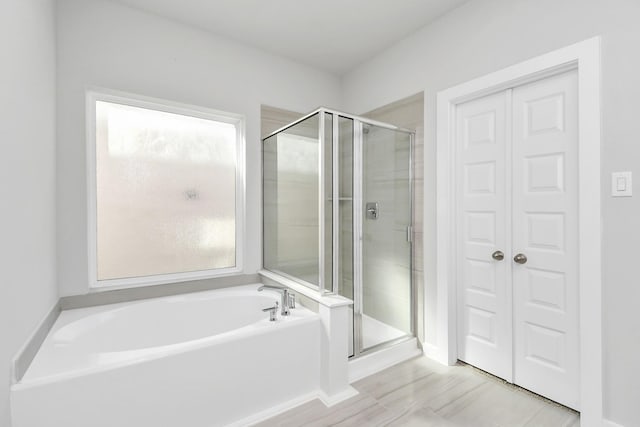 12027 Maple Oak Dr, Houston, TX 77066 - bathroom featuring a stall shower, a garden tub, and baseboards