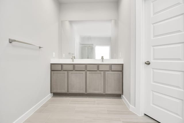 12027 Maple Oak Dr, Houston, TX 77066 - bathroom featuring a stall shower, double vanity, and baseboards