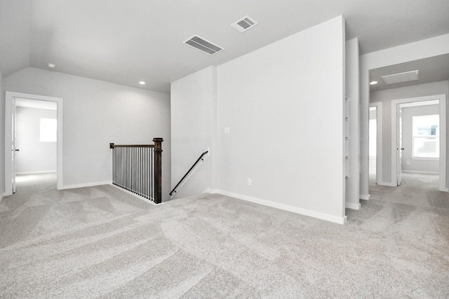 12027 Maple Oak Dr, Houston, TX 77066 - empty room featuring light carpet, baseboards, lofted ceiling, healthy amount of natural light, and recessed lighting