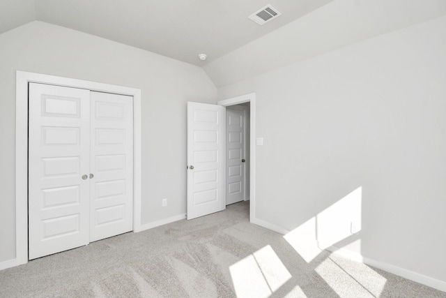 12027 Maple Oak Dr, Houston, TX 77066 - unfurnished bedroom with lofted ceiling, carpet, baseboards, and a closet