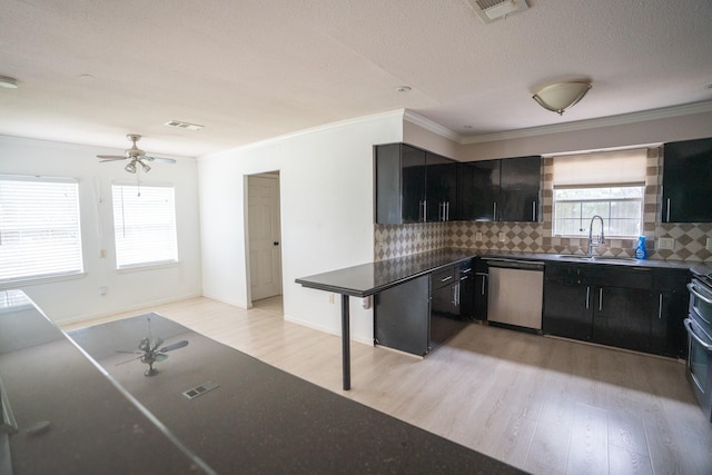 5507 W Bellfort Ave, Houston, TX 77035 - kitchen with dishwasher, ceiling fan, dark cabinets, light wood-style flooring, and a sink