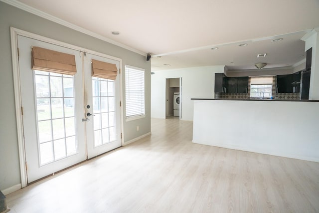 5507 W Bellfort Ave, Houston, TX 77035 - unfurnished living room with french doors, ornamental molding, light wood-style flooring, recessed lighting, and washer / clothes dryer