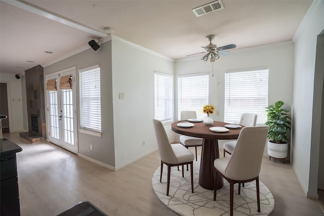 5507 W Bellfort Ave, Houston, TX 77035 - dining space with light wood finished floors, baseboards, ceiling fan, and crown molding