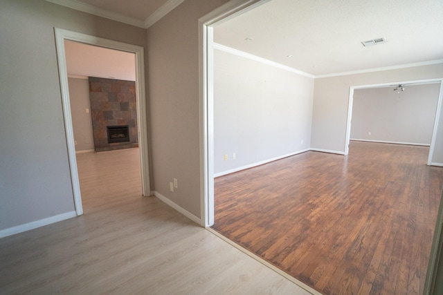 5507 W Bellfort Ave, Houston, TX 77035 - unfurnished room with wood finished floors, baseboards, a large fireplace, and ornamental molding