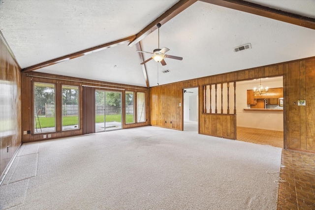 2718 Leichester Dr, Spring, TX 77386 - unfurnished living room featuring wood walls, beamed ceiling, a chandelier, a ceiling fan, and high vaulted ceiling