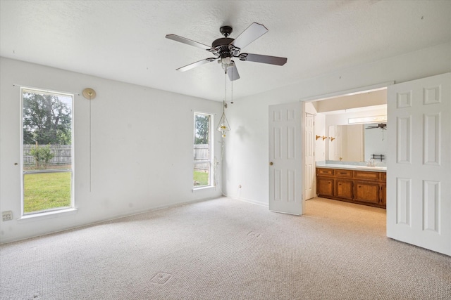 2718 Leichester Dr, Spring, TX 77386 - unfurnished bedroom featuring multiple windows, light colored carpet, connected bathroom, and baseboards