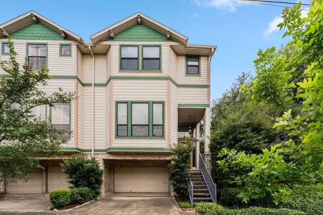 1335 Fairview Ave, Houston, TX 77006 - view of front facade featuring an attached garage, stairway, and driveway