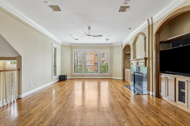 1335 Fairview Ave, Houston, TX 77006 - unfurnished living room with ceiling fan, healthy amount of natural light, a fireplace, ornamental molding, and light wood finished floors