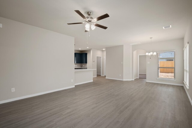 22606 Rosy Heights Trl, Tomball, TX 77377 - unfurnished living room featuring wood finished floors, ceiling fan, a chandelier, baseboards, and recessed lighting