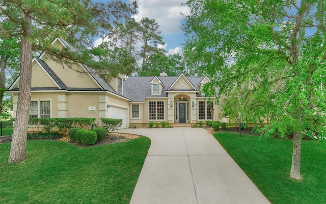 145 W Shore Dr, Montgomery, TX 77356 - traditional-style house with concrete driveway, a front lawn, stucco siding, a chimney, and a shingled roof