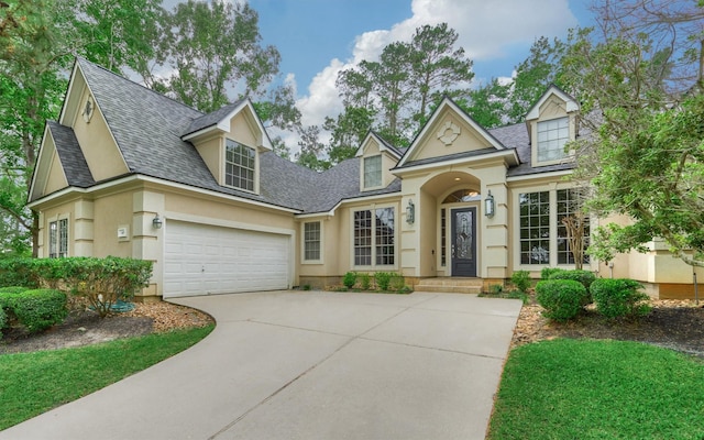145 W Shore Dr, Montgomery, TX 77356 - view of front of property featuring stucco siding, concrete driveway, roof with shingles, and a garage