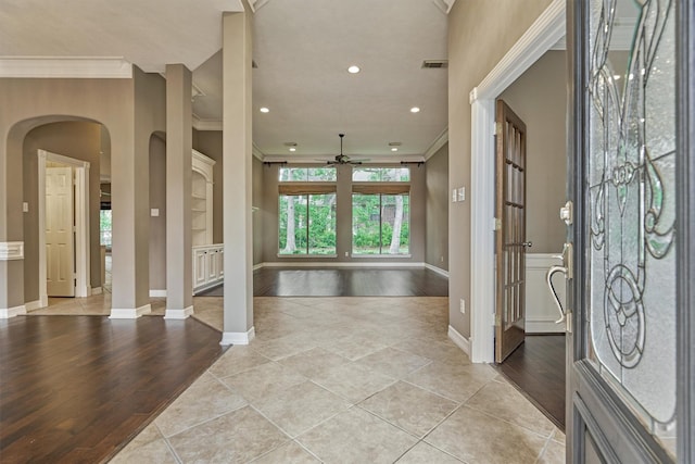 145 W Shore Dr, Montgomery, TX 77356 - foyer entrance featuring a ceiling fan, crown molding, arched walkways, light tile patterned floors, and baseboards