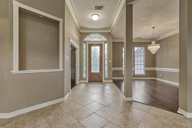 145 W Shore Dr, Montgomery, TX 77356 - entrance foyer with tile patterned flooring, baseboards, a chandelier, and crown molding