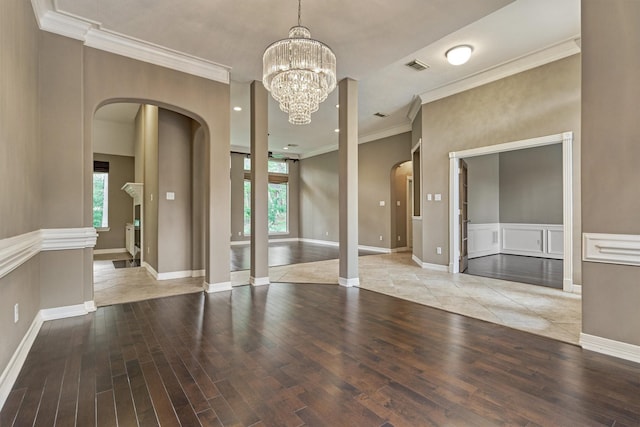 145 W Shore Dr, Montgomery, TX 77356 - spare room with arched walkways, plenty of natural light, wood finished floors, ornamental molding, and baseboards