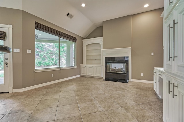 145 W Shore Dr, Montgomery, TX 77356 - unfurnished living room with light tile patterned floors, vaulted ceiling, recessed lighting, baseboards, and a tile fireplace