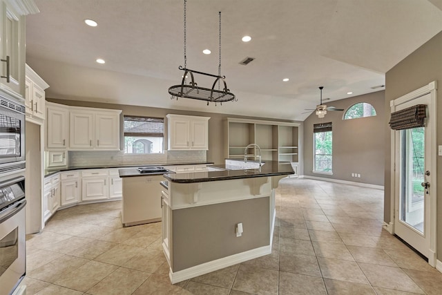 145 W Shore Dr, Montgomery, TX 77356 - kitchen with a kitchen island with sink, recessed lighting, a sink, stainless steel appliances, and tasteful backsplash