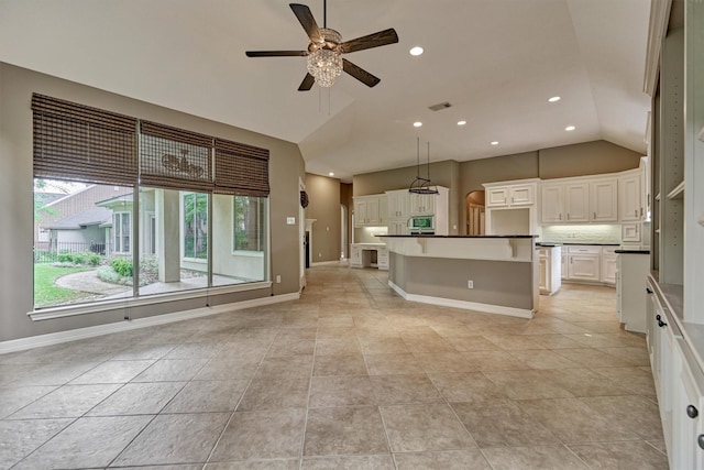 145 W Shore Dr, Montgomery, TX 77356 - unfurnished living room featuring lofted ceiling, ceiling fan, light tile patterned floors, baseboards, and recessed lighting