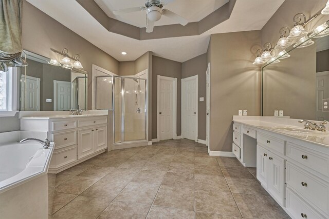 145 W Shore Dr, Montgomery, TX 77356 - full bathroom with a stall shower, ceiling fan, a bath, two vanities, and a tray ceiling