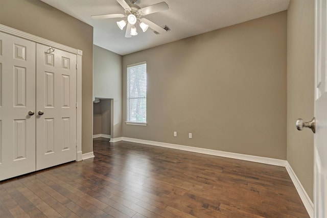 145 W Shore Dr, Montgomery, TX 77356 - unfurnished bedroom featuring dark wood-type flooring, baseboards, a closet, and a ceiling fan