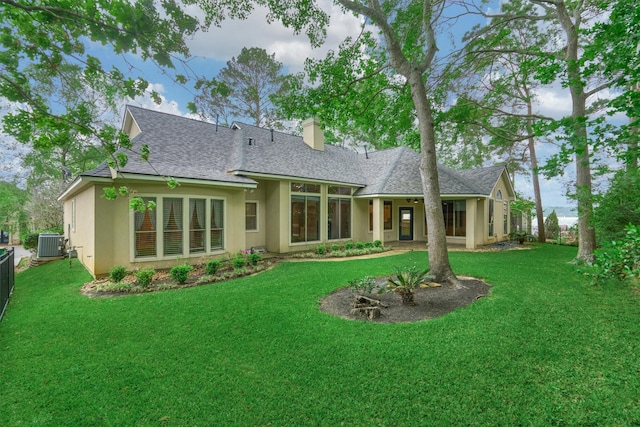 145 W Shore Dr, Montgomery, TX 77356 - back of house with a shingled roof, a chimney, stucco siding, and central air condition unit