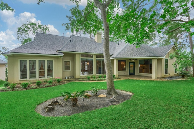 145 W Shore Dr, Montgomery, TX 77356 - rear view of property featuring roof with shingles, a chimney, stucco siding, and a yard