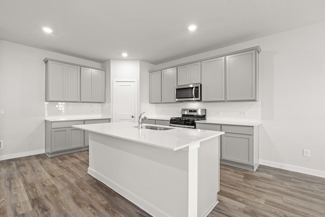 5803 Grantgrala Dr, Katy, TX 77493 - kitchen with gray cabinets, appliances with stainless steel finishes, a sink, and recessed lighting