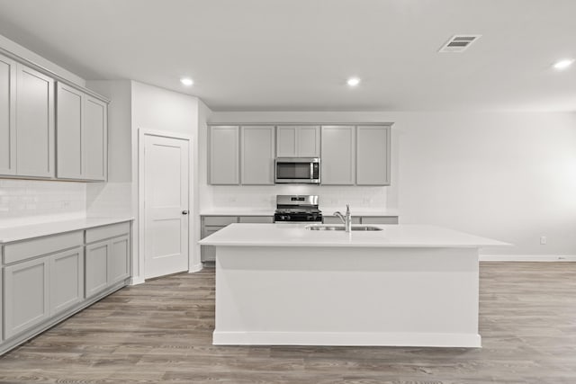 5803 Grantgrala Dr, Katy, TX 77493 - kitchen featuring stainless steel appliances, gray cabinetry, a sink, tasteful backsplash, and recessed lighting