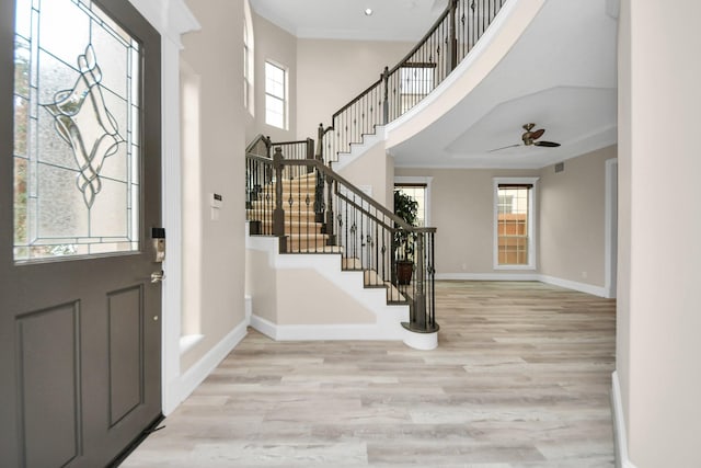 13523 Broadmeadow Ln, Houston, TX 77077 - foyer entrance featuring light wood-style floors, stairway, baseboards, healthy amount of natural light, and a towering ceiling