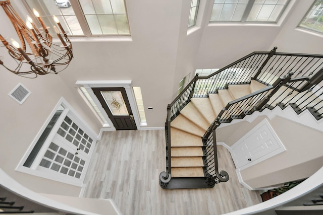13523 Broadmeadow Ln, Houston, TX 77077 - foyer featuring wood finished floors, a towering ceiling, stairway, a chandelier, and baseboards