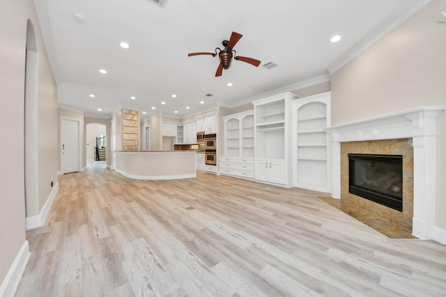 13523 Broadmeadow Ln, Houston, TX 77077 - unfurnished living room with crown molding, a ceiling fan, a tiled fireplace, recessed lighting, and light wood-type flooring