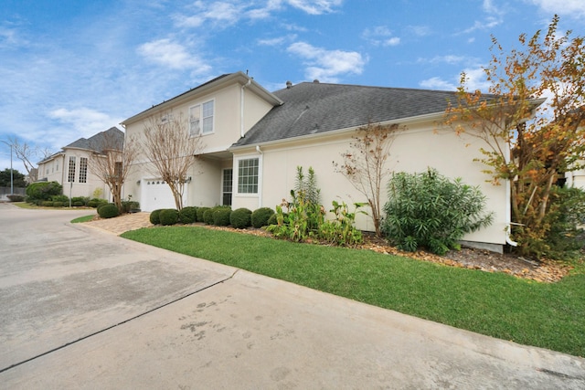 13523 Broadmeadow Ln, Houston, TX 77077 - view of front facade featuring stucco siding, driveway, a front yard, and an attached garage