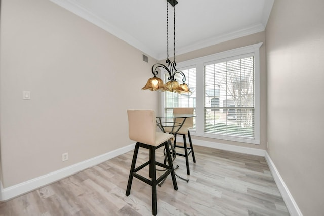 13523 Broadmeadow Ln, Houston, TX 77077 - dining room featuring crown molding, a chandelier, baseboards, and light wood-style floors