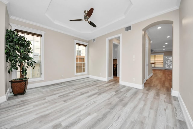13523 Broadmeadow Ln, Houston, TX 77077 - empty room with a ceiling fan, a raised ceiling, light wood finished floors, arched walkways, and recessed lighting