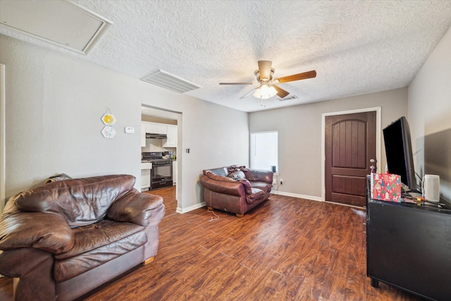 5542 Margarita St, Houston, TX 77020 - living area featuring a ceiling fan, dark wood-type flooring, a textured ceiling, and baseboards