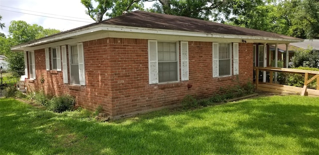 836 Sycamore St, Lake Jackson, TX 77566 - view of home's exterior with brick siding and a lawn