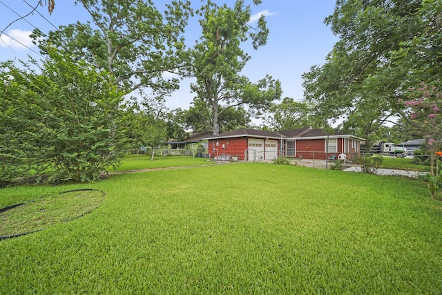 836 Sycamore St, Lake Jackson, TX 77566 - view of yard featuring a garage