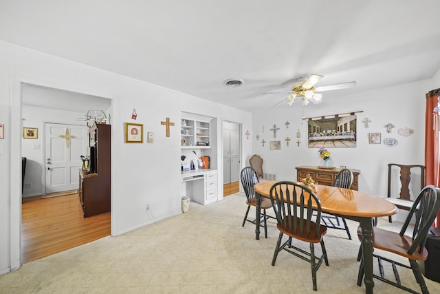 836 Sycamore St, Lake Jackson, TX 77566 - dining area featuring a ceiling fan, light carpet, and built in features