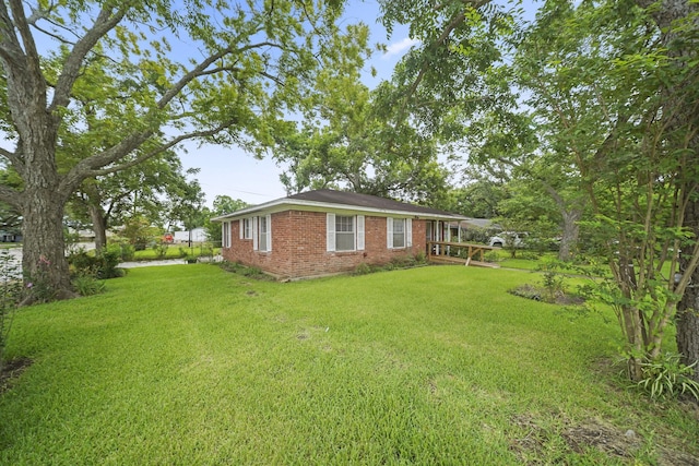 836 Sycamore St, Lake Jackson, TX 77566 - exterior space featuring brick siding and a lawn
