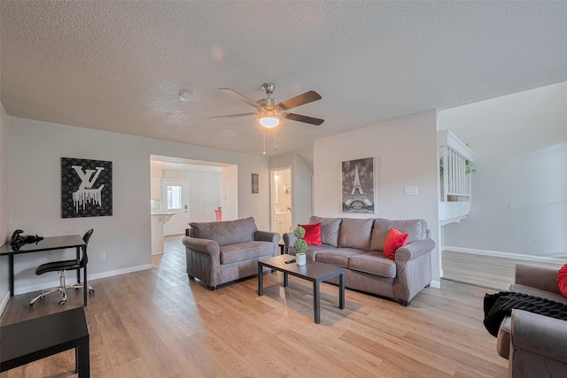 5825 Village Forest Ct, Houston, TX 77092 - living area featuring light wood finished floors, a textured ceiling, baseboards, and ceiling fan