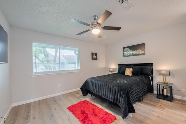 5825 Village Forest Ct, Houston, TX 77092 - bedroom featuring wood finished floors, baseboards, ceiling fan, and a textured ceiling